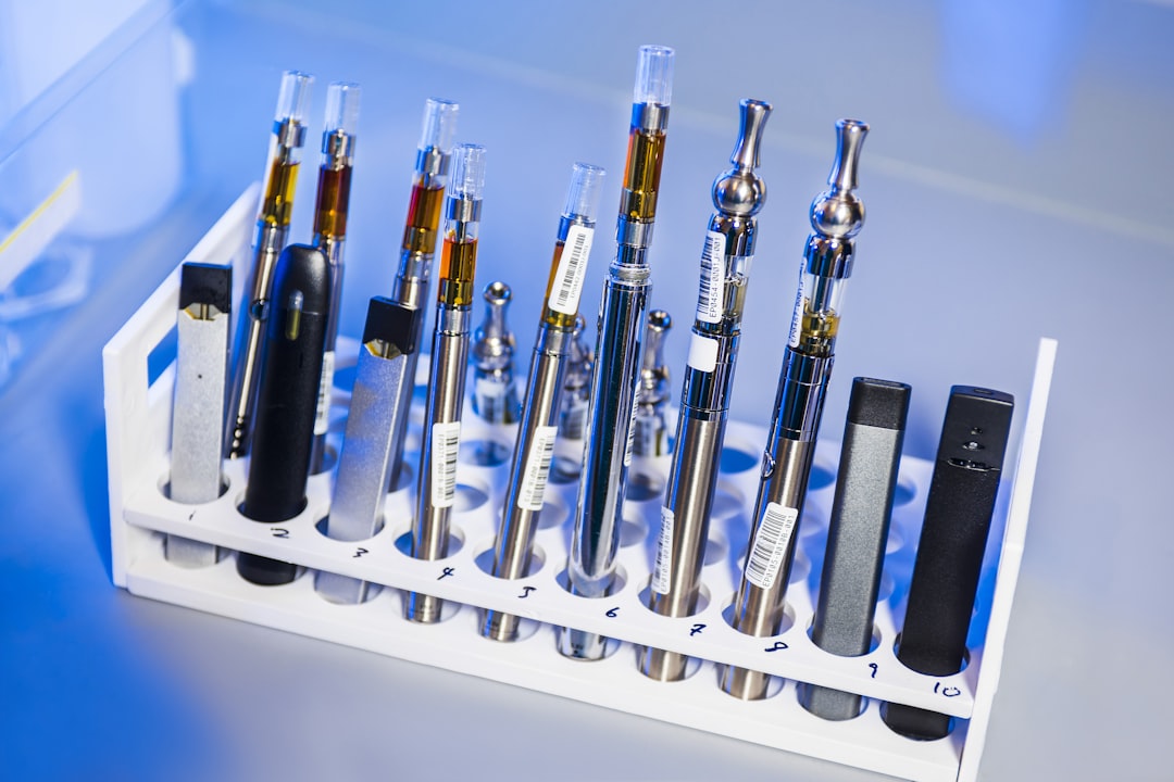 assorted vape pens arranged in white holder