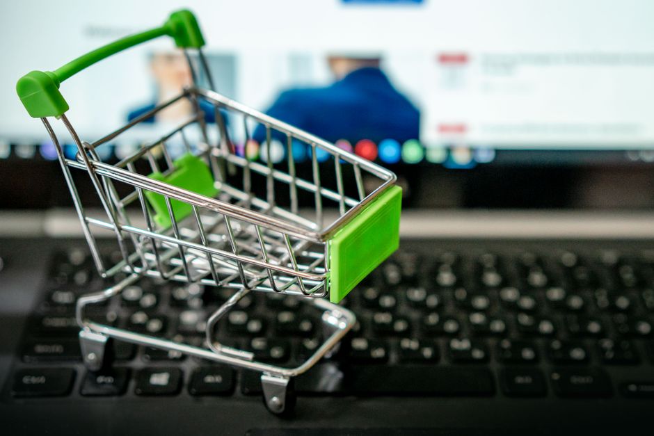 Mini shopping cart on laptop keyboard