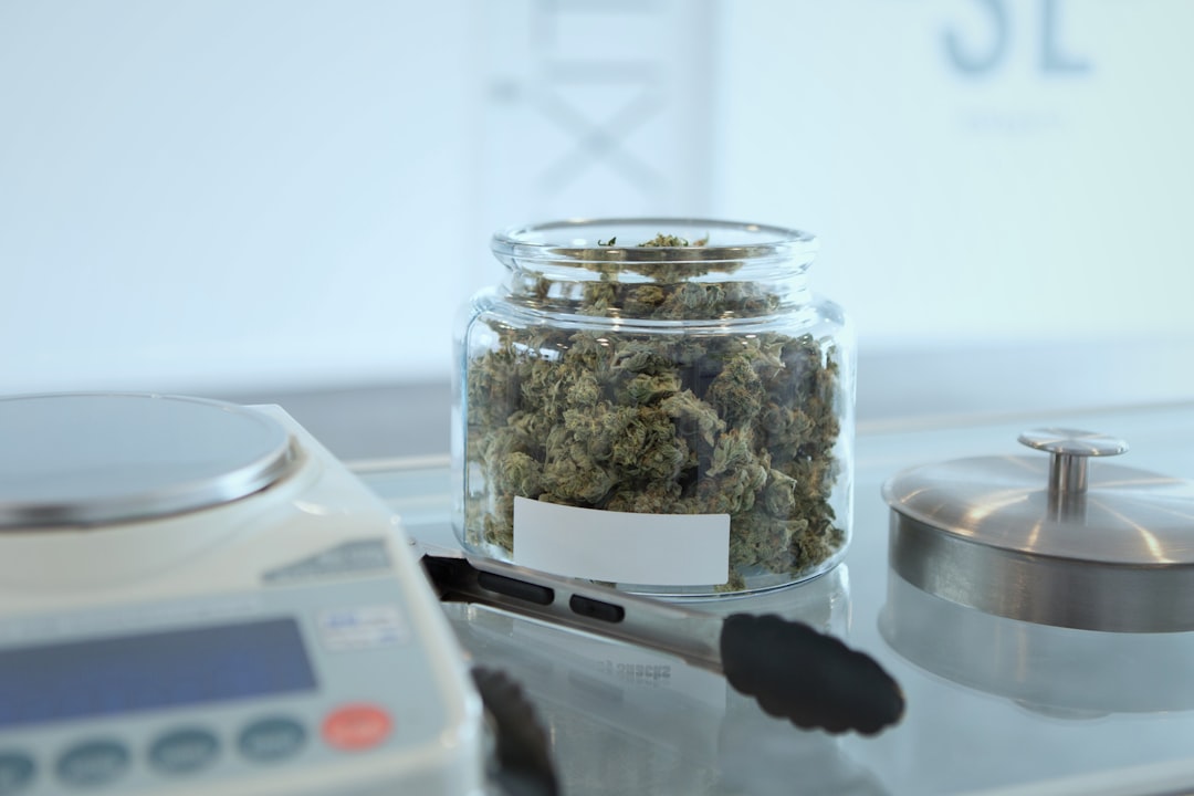 Glass jar of cannabis buds on counter