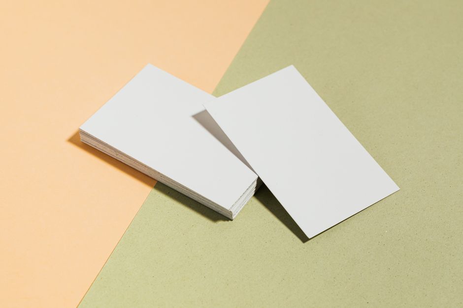 Blank business cards on colored background