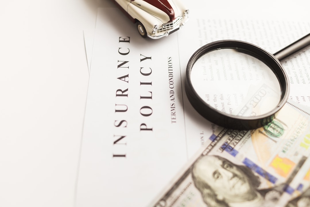 Car insurance policy document magnifying glass money
