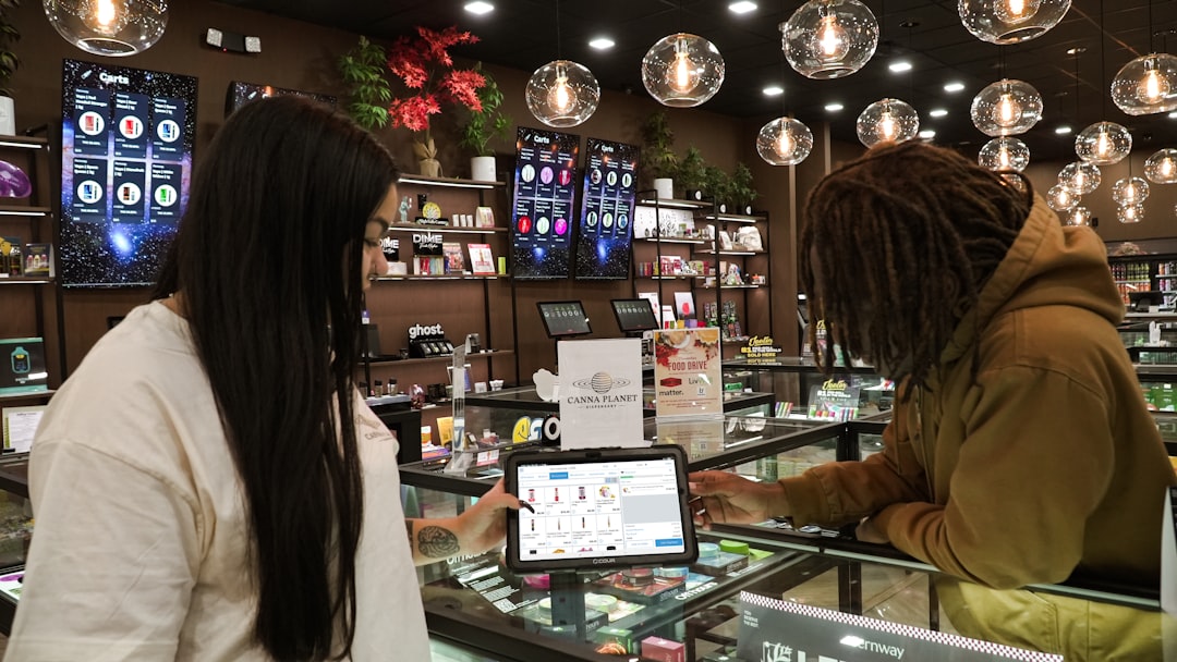 Two people using a tablet inside dispensary