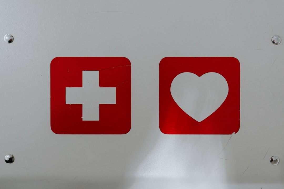Red cross and heart icons on white