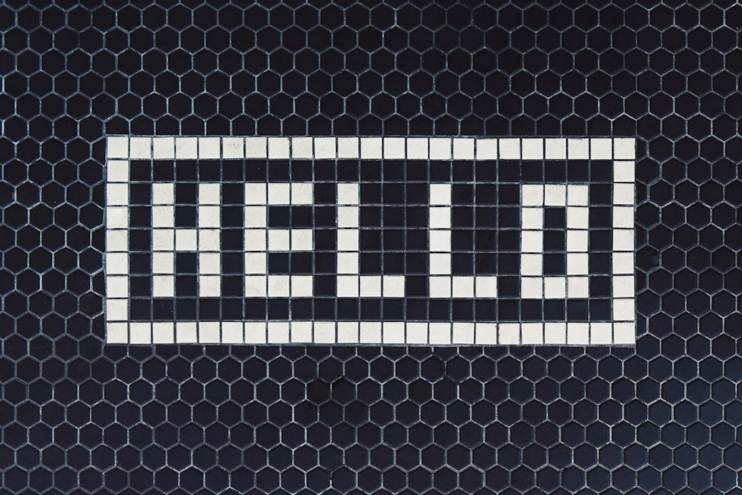 White hello on black tiled background